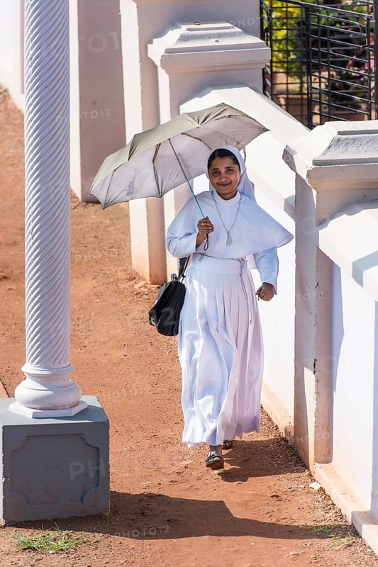 Smiling nun with parasol