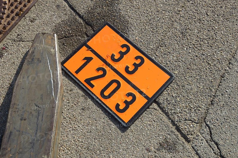 Sign indicating dangerous goods next to a forklift on the ground