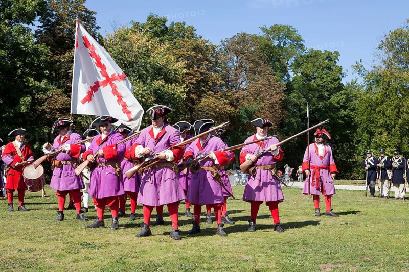 Soldiers with muzzle-loading rifles shooting during live role-playing or ReenLarpment