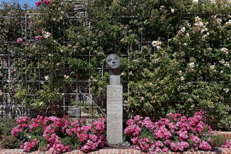 Rose garden with a statue of Christian Dior