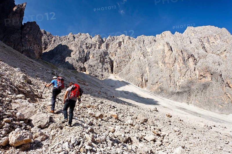 Hikers climbing to the summit of Plattkofel mountain