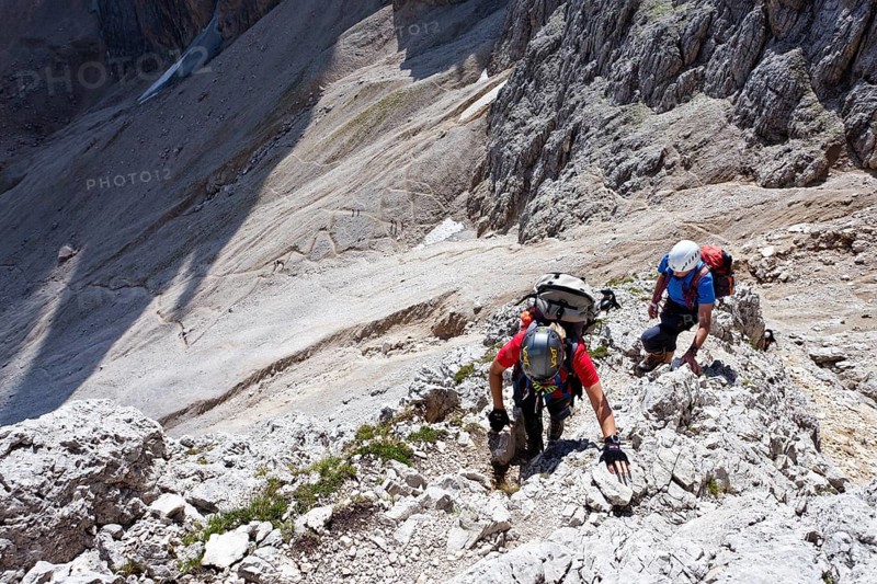Hikers climbing to the summit of Plattkofel mountain