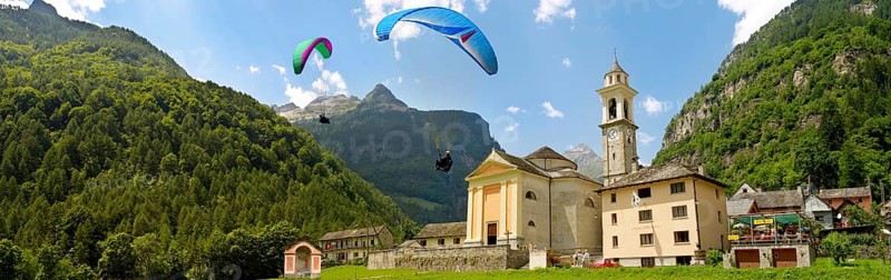 Paragliders over the baroque church at Sonogno