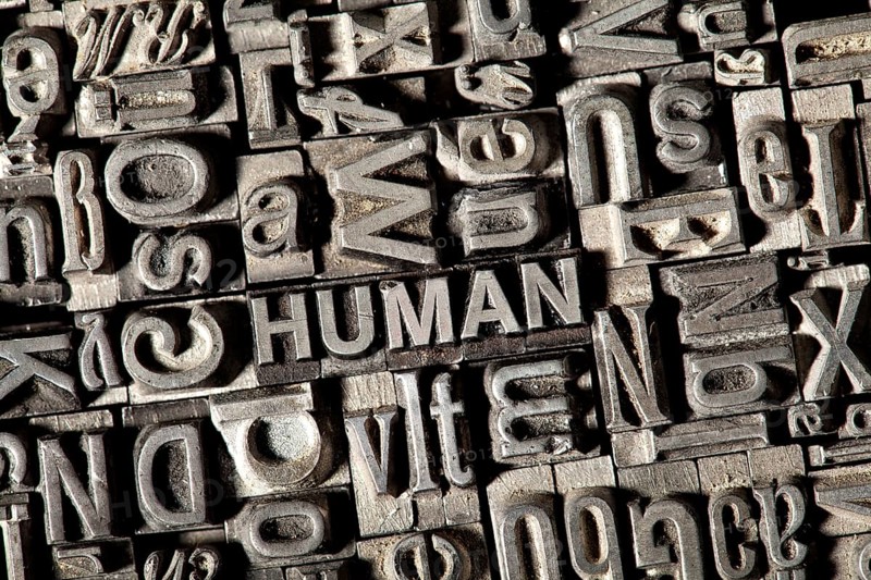 Old lead letters forming the word HUMAN