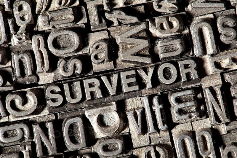 Old lead letters forming the word 'SURVEYOR'