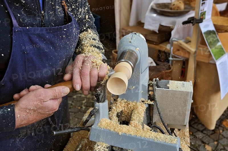 Man using a wood lathe at the Kirchweihmarkt market