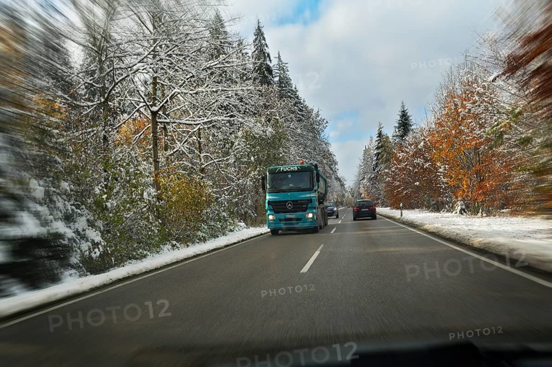 A country road through a snowy forest near Feldkirchen-Westerham