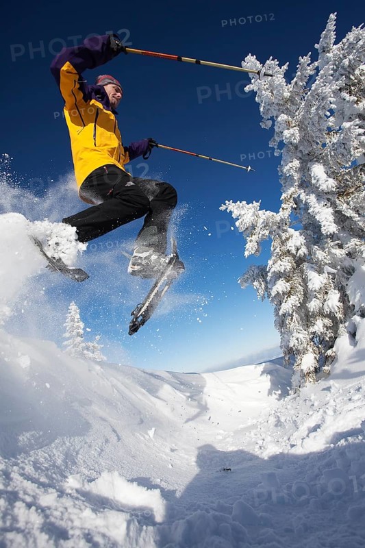 Snowshoe hiker jumping