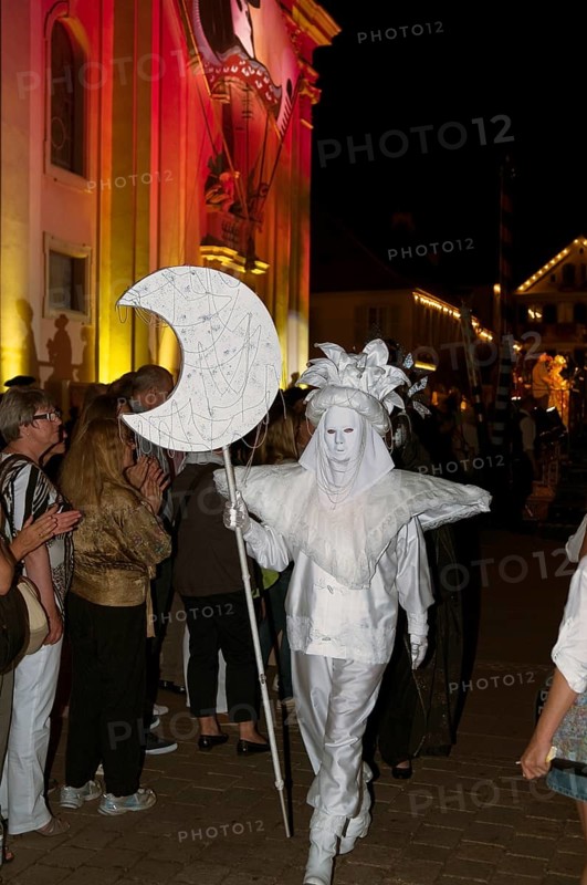 Parade of mask wearers in front of the historic municipal church