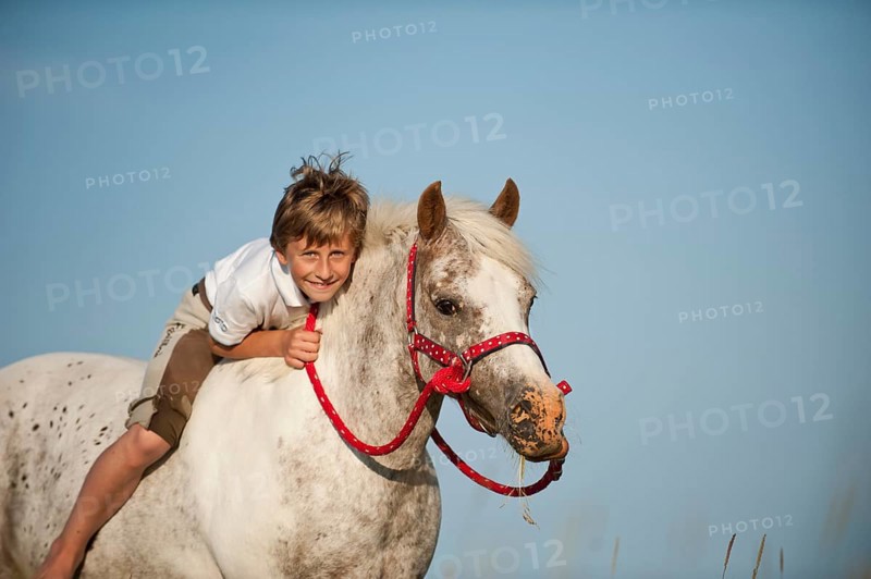 Girl riding a pony bareback