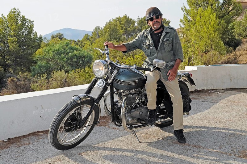 Elderly man sitting on a Triumph Tiger 500cc motorbike