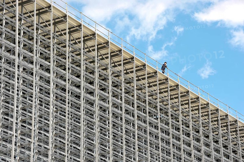 Worker on the roof of a high bay warehouse during construction