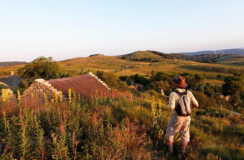 Hiker at water mill in the village of L'Hopital
