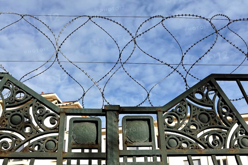 Barbed wire around abandoned building