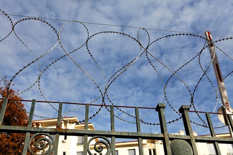 Barbed wire around abandoned building