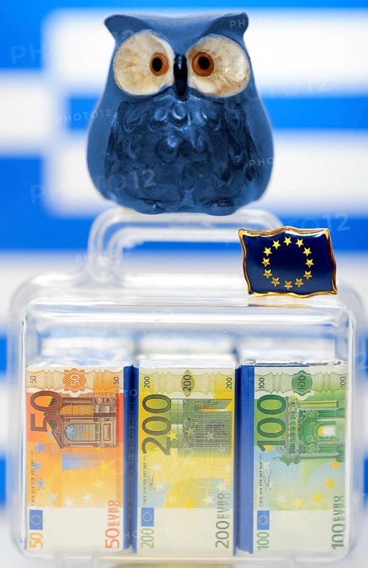Owl on a suitcase full of money in front of a Greek flag