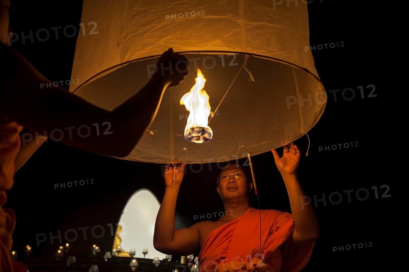 Monks releasing a Kongming lantern or sky lantern for luck during the Loi Krathong or Loy Gratong Festival