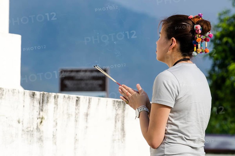 Woman holding incense sticks