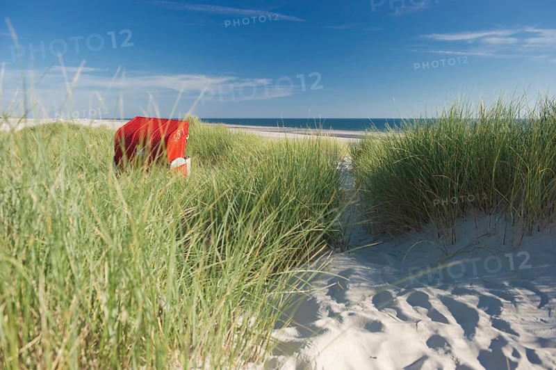 Dunes and red roofed wicker beach chair