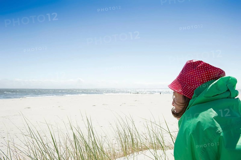 A woman sitting on the beach