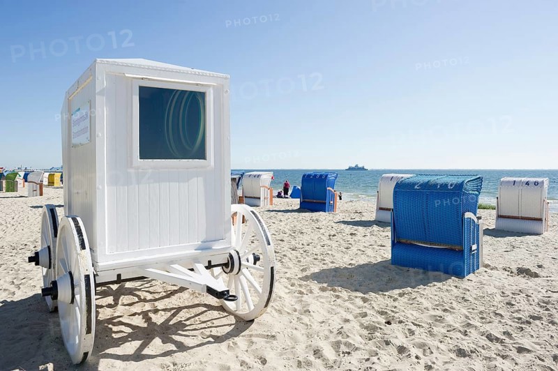 Colourful roofed wicker beach chairs and a historical cabana on the beach near Wyk