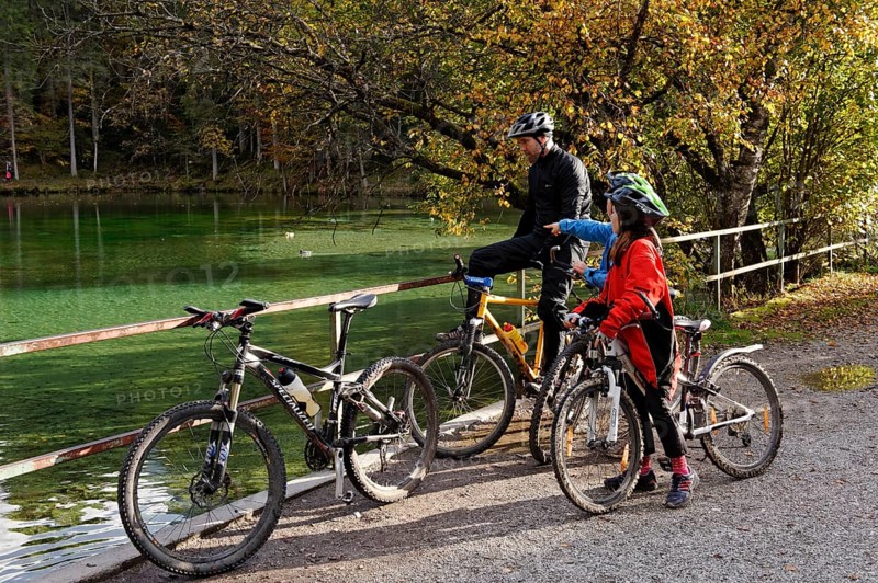 Father and children riding mountain bikes