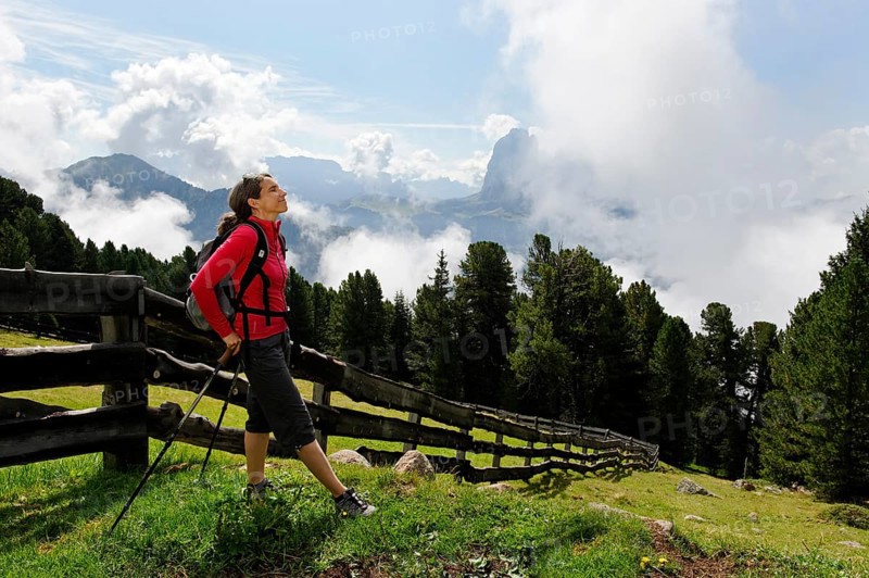 Hiker at the Raschotz or Rasciesa mountain pasture with Mt. Sasso Lungo