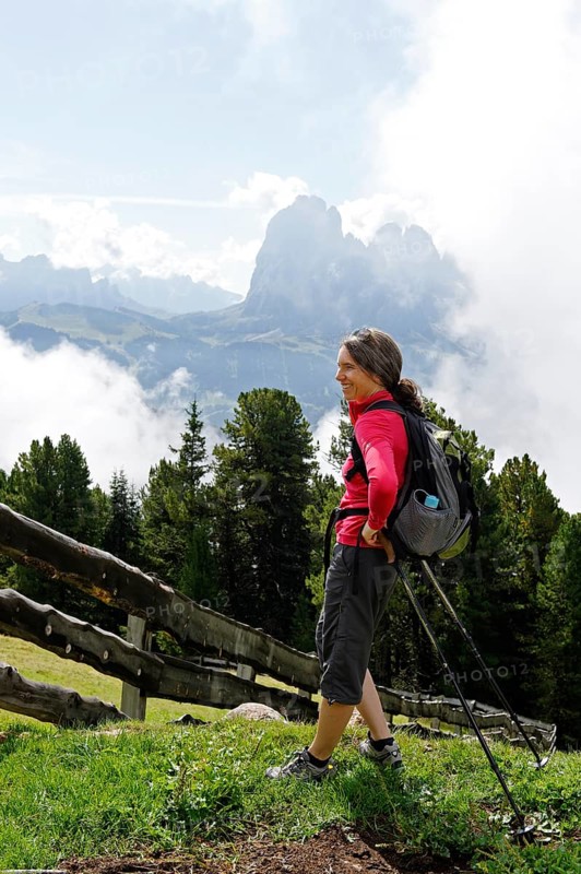 Hiker at the Raschotz or Rasciesa mountain pasture with Mt. Sasso Lungo