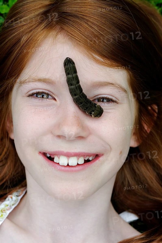Girl with a caterpillar on her face