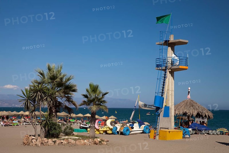 Palm trees and the tower of the lifeguards on Hawaii Playa beach