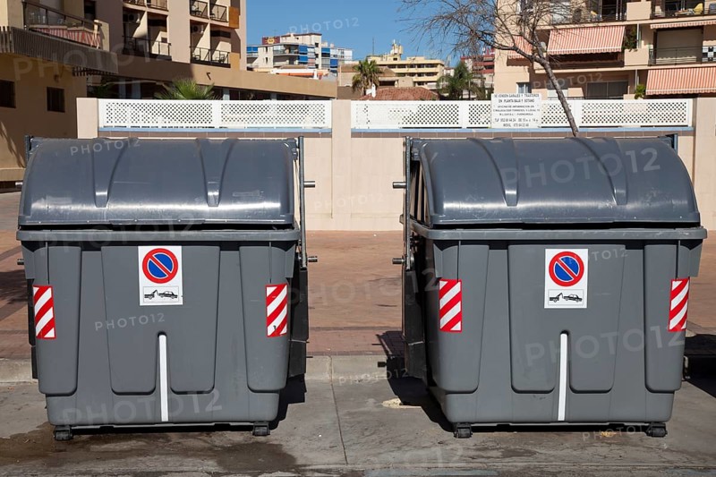 Wheeled trash cans standing on the roadside