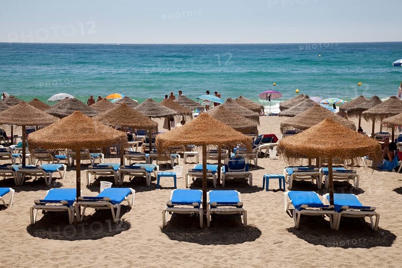 Sun beds and umbrellas on the sandy beach