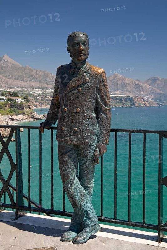 Statue of El Rey Alfonso XII on the observation deck of Balcon de Europa overlooking the beach and coast in Nerja