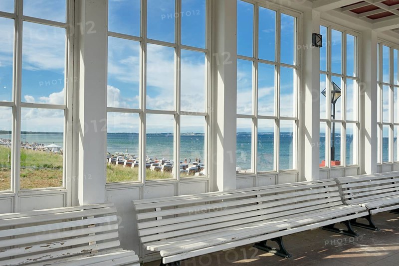Looking through the window of the pavilion of the Kurhaus spa building towards the Baltic Sea and the beach