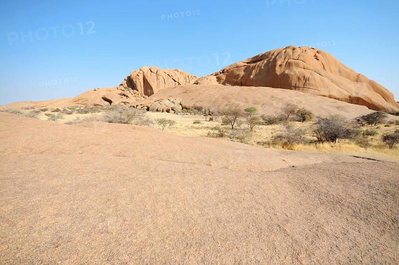 Savannah landscape with granite rocks and Spitzkoppe Mountain
