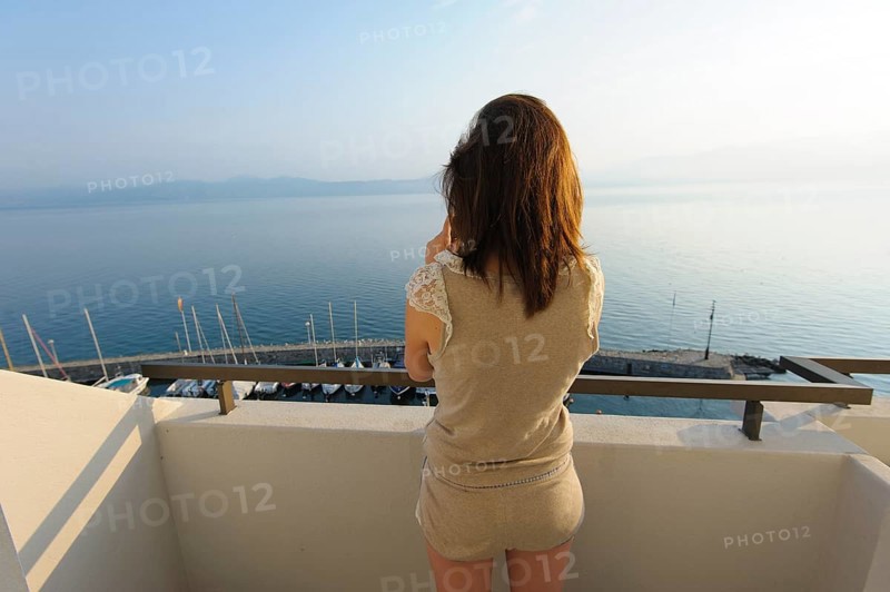 Young woman standing on a balcony