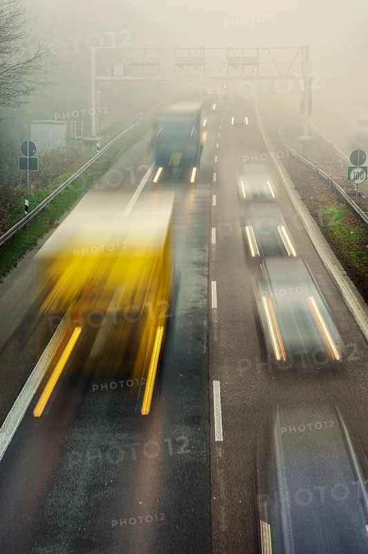 Rush hour on a motorway with early morning fog