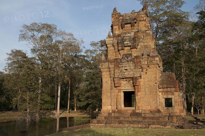View of Khmer temple tower beside pond