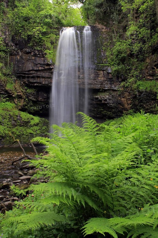 Waterfall flowing over faulted edge of hard sandstone