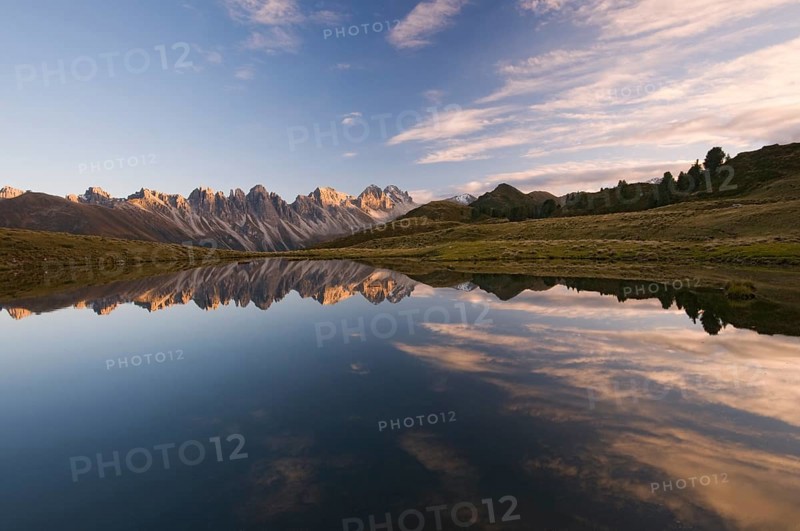 Kalkkoegel mountain range reflected in a small mountain lake