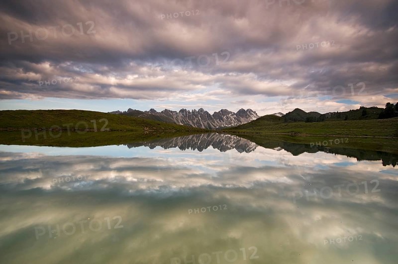 Kalkkoegel mountain range reflected in a small lake