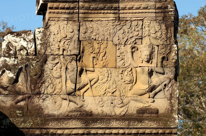 Bas-relief carved in stone depicting two dancing apsaras