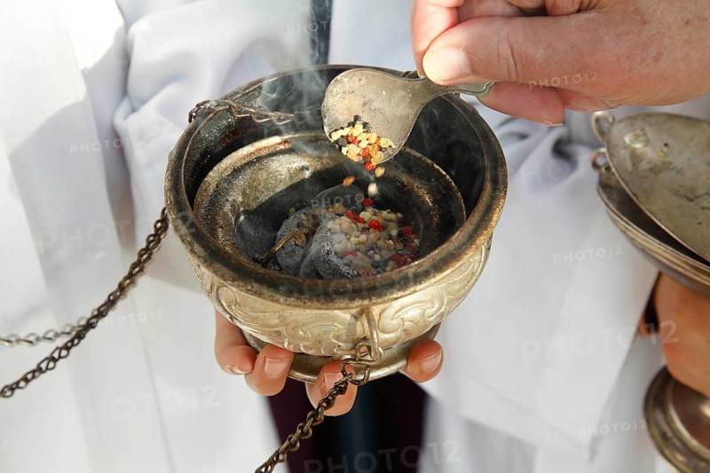 Frankincense being scattered in a censer