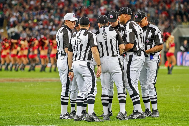The referee crew discusses a ruling during the NFL International game between the Tampa Bay Buccaneers and the Chicago Bears on October 23