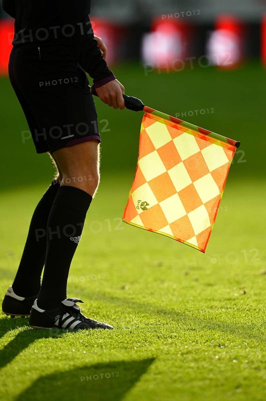 Linesman holding a flag with backlighting