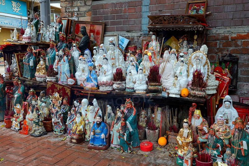 Adoration figures with incense on a small altar in the street