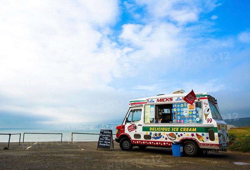 An ice cream van is parked on a coastal car park above Compton Bay on the Isle of Wight
