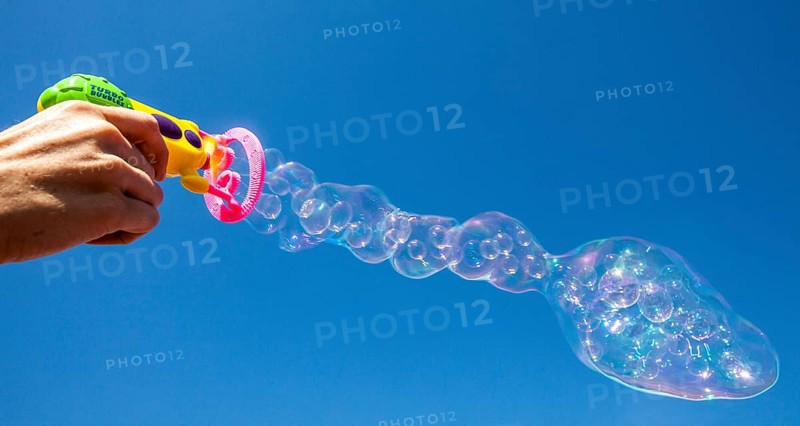 Smaller soap bubbles enclosed in larger bubbles from a bubble machine