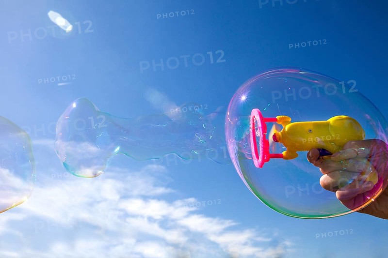 Smaller soap bubbles enclosed in larger bubbles from a bubble machine