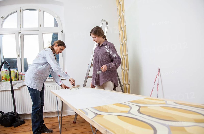 Mother and daughter renovating a room